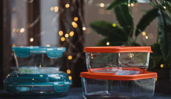 Empty glass food storage container on a dark neutral surface