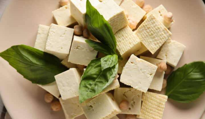 Tofu, beans, and soy in a bowl on a light background, plant-based protein ingredients for meal prep