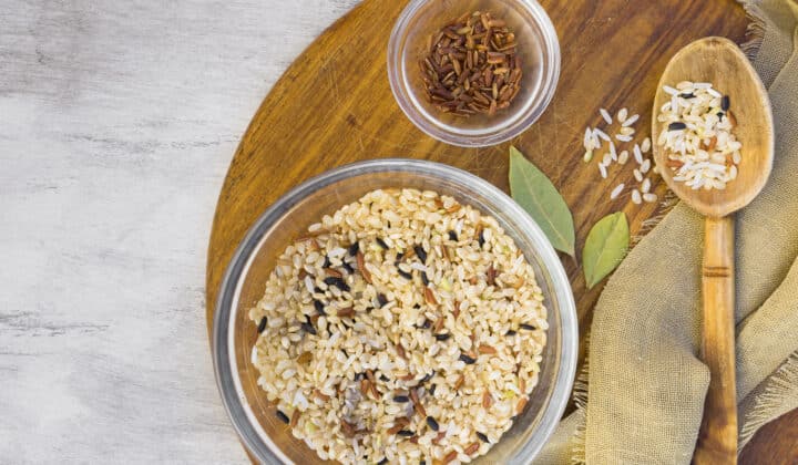 Bowls of dry rice and grains on a light table
