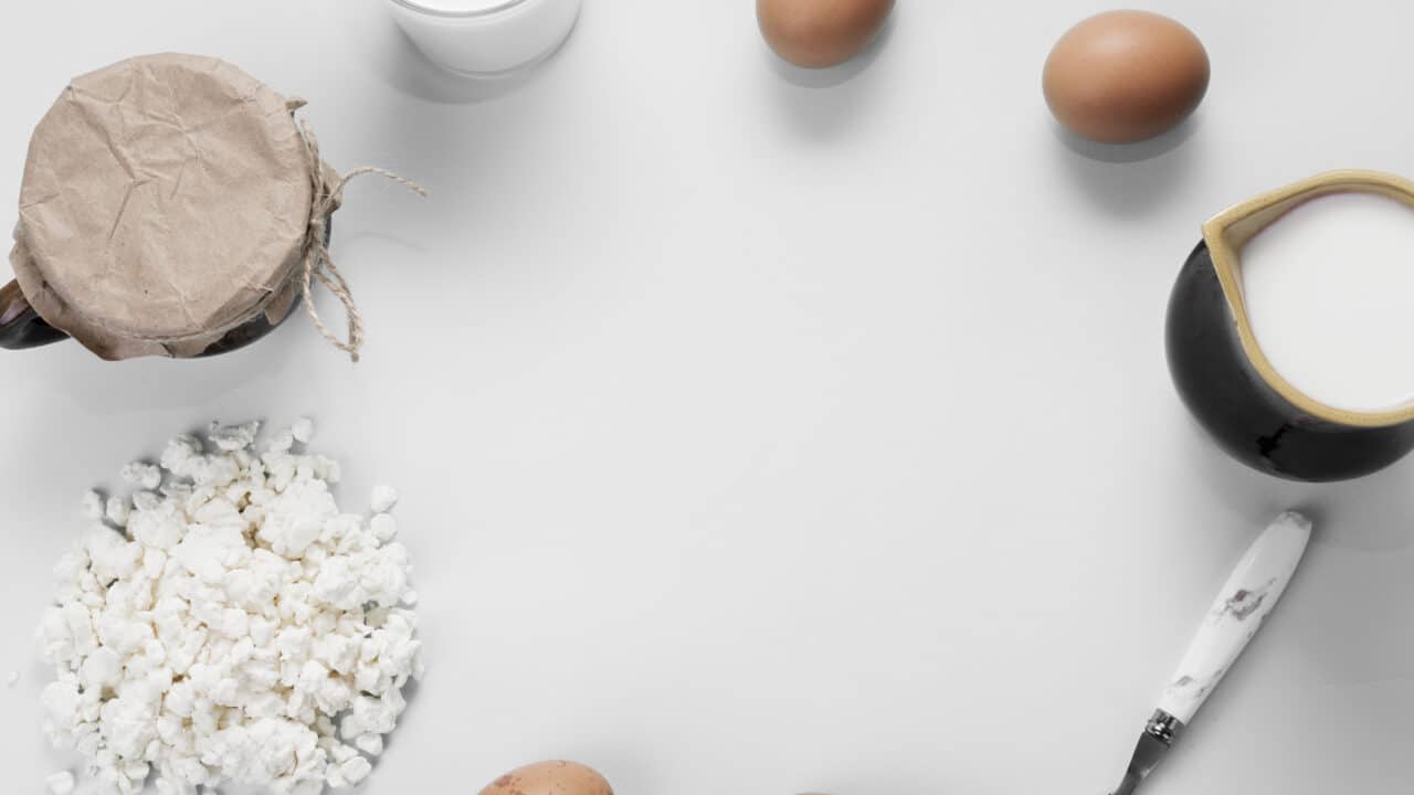 Flat lay of raw high-protein meal prep ingredients on a neutral background