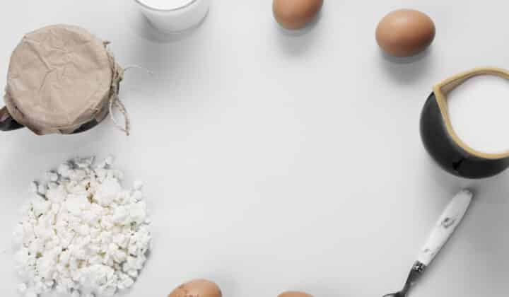 Flat lay of raw high-protein meal prep ingredients on a neutral background