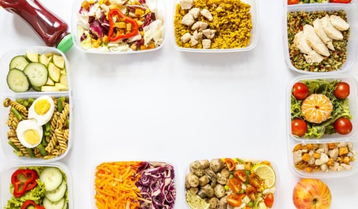 Flat-lay of batch-cooked meal prep containers arranged for the week
