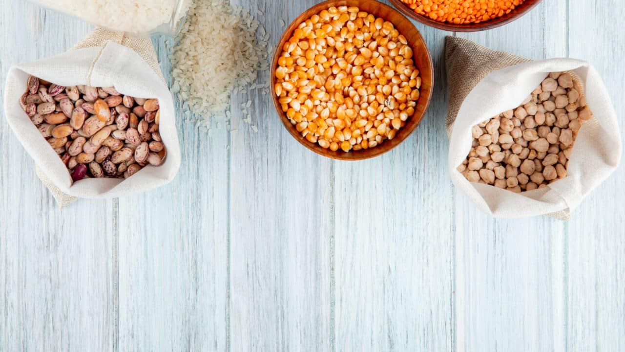 Bowls of dried beans, rice, lentils and chickpeas, the cheapest meal prep staples