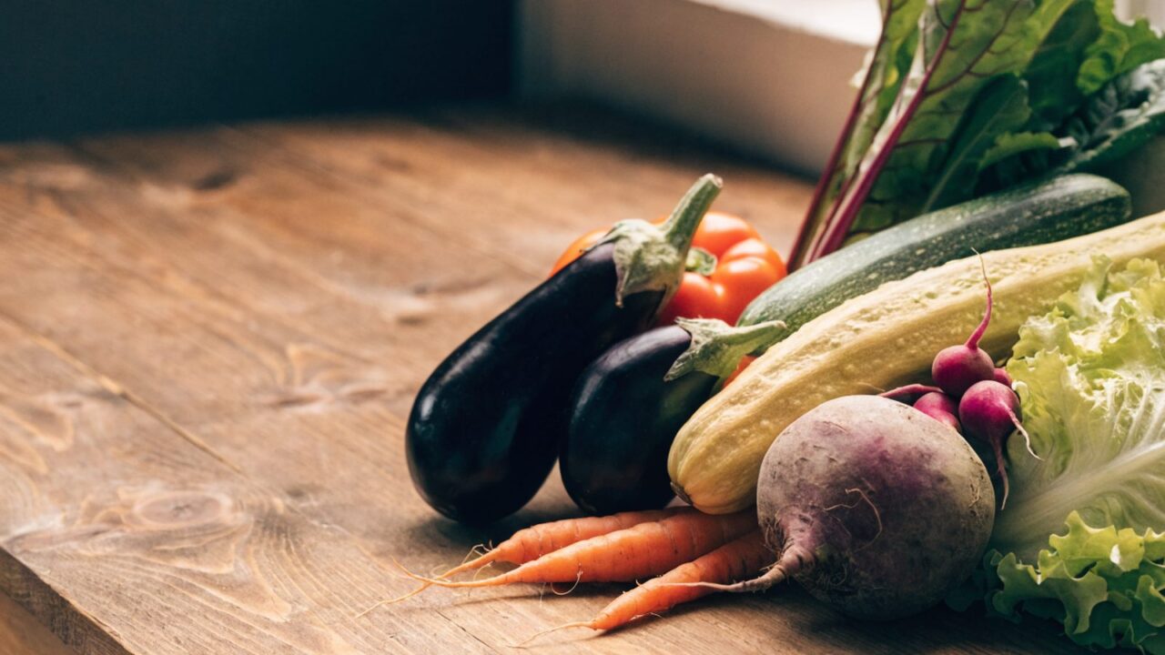 Colorful assortment of fresh vegetables on a wooden background