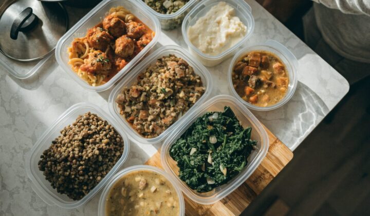 Individual pre-cooked meal portions in labeled freezer containers prepared before a baby's arrival