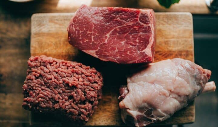 Assortment of raw meats on a cutting board