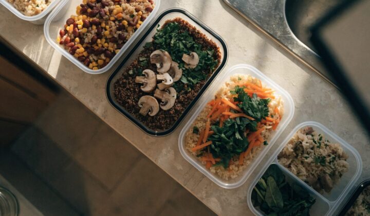 Meal-prep storage containers organized with prepared meals, top-down view