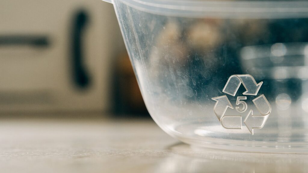 Recycling resin code number 5 stamped on the base of a clear polypropylene meal prep container