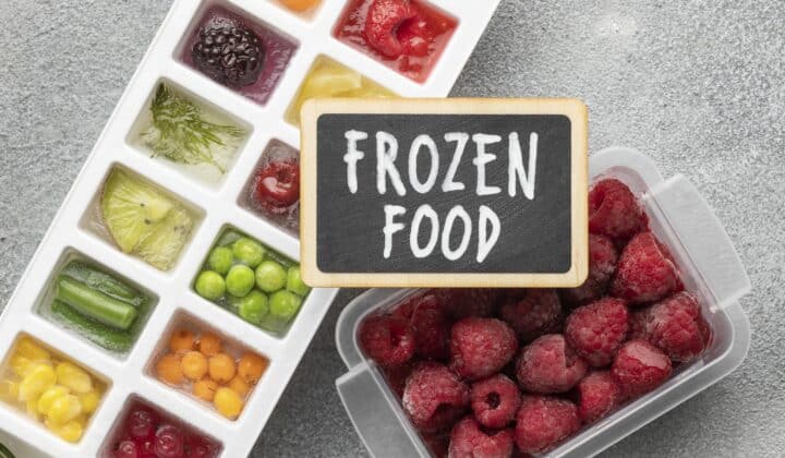 Flat lay of frozen vegetables and fruit in bags and containers, the kind of batches a freezer inventory sheet tracks